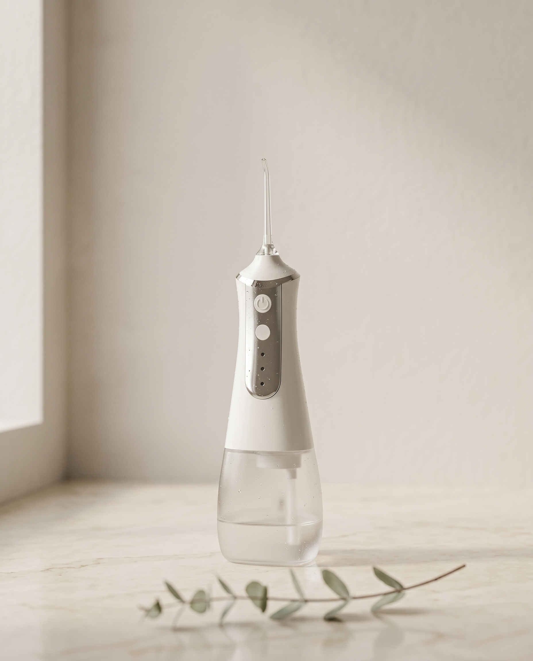 HydroPearl cordless water flosser on a marble bathroom counter, editorial product photo